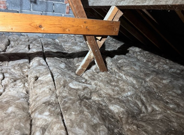 Loft insulation around timbers